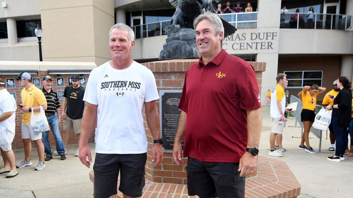 Former Northeast Louisiana player and current Philadelphia Eagles head coach Doug Pederson, right, and former NFL and Southern Mississippi quarterback Brett Favre pose for pictures outside the stadium in Hattiesburg on Sept. 8.