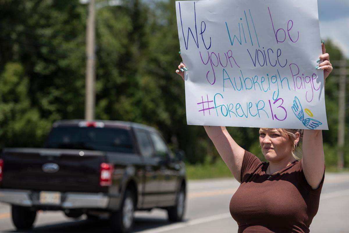 Vanessa Owens holds up a sign against bullying outside the Ocean Springs Middle School in Ocean Springs on Thursday, Sept. 7, 2023. A middle school girl died unexpectedly after being bullied at the school.