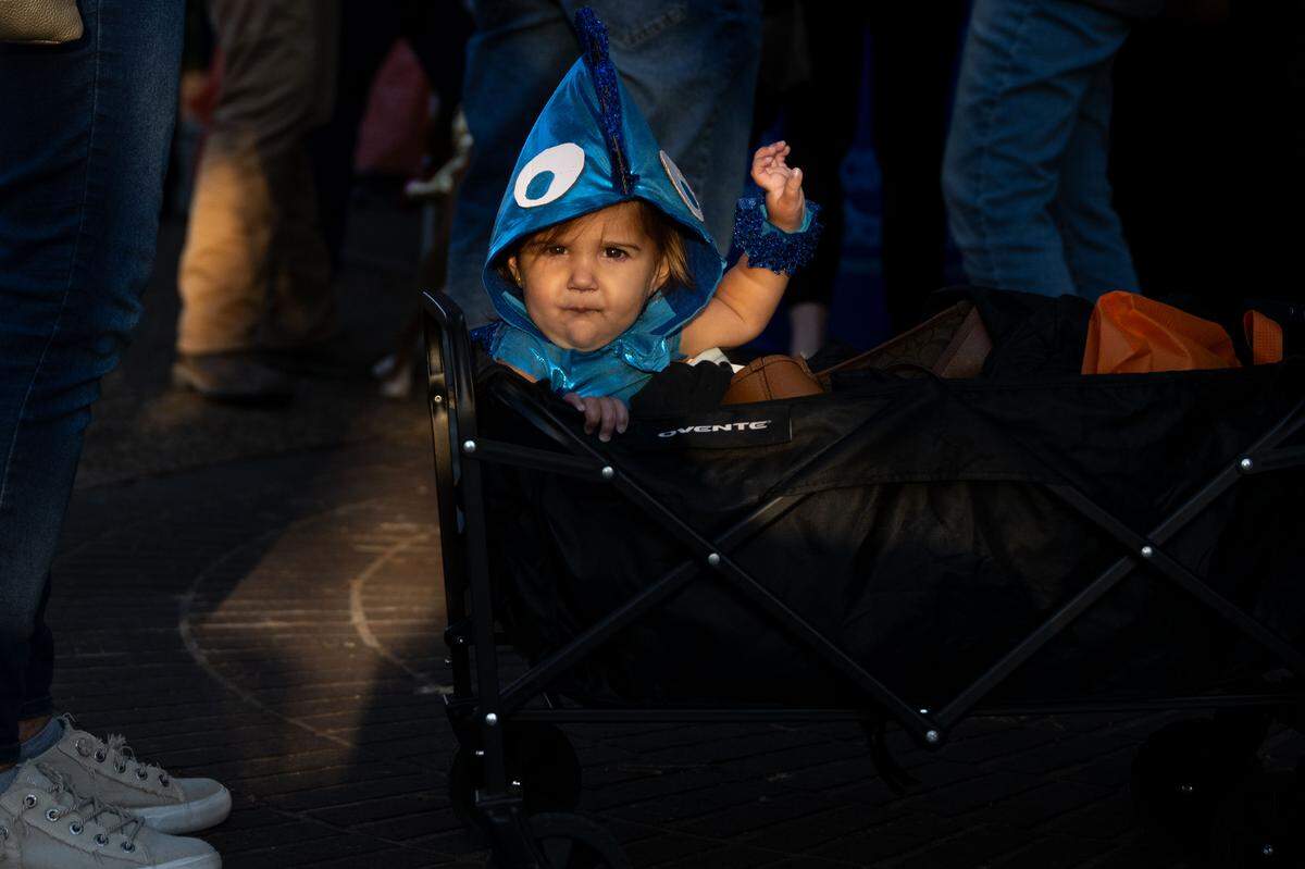 Ruth Pickich is wheeled around in a cart during Boo On The Rue in Biloxi on Thursday, October 30, 2025.