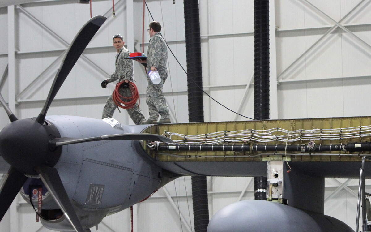 Tech Sgt. Michael Rutherford, left, and Staff Sgt. Matthew Sladon of the 403rd maintenance group walk down the wing of a Hurricane Hunter's WC130-J at Keesler Air Force Base in Biloxi on Thursday March 24, 2016. The 403rd Wing will get an additional maintenance squadron to help maintain the Hurricane Hunters and Flying Jennies.