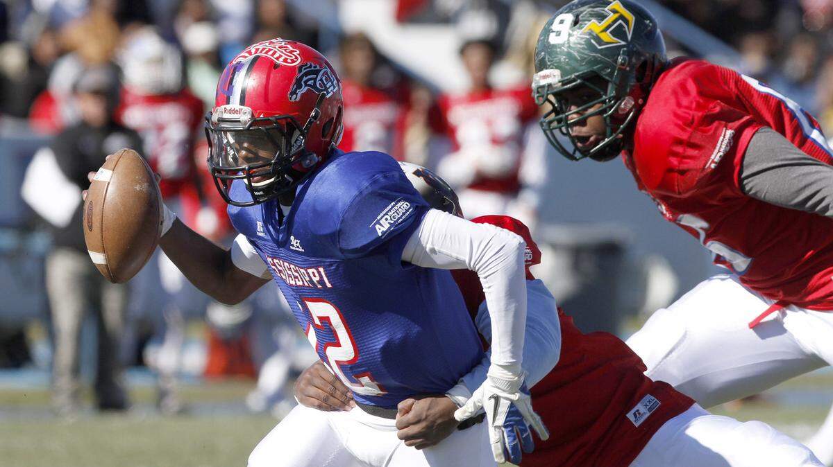 TIM ISBELL/SUN HERALD 
 North quarterback Dan Ellington tries to scramble out of pressure during the Bernard Blackwell All Star game, Saturday, Dec. 19, 2015.