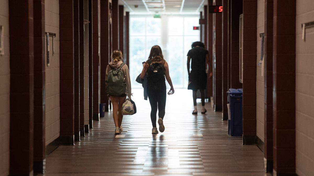 Students walk along a hallway at Long Beach High School on Thursday, Sept. 26, 2024.