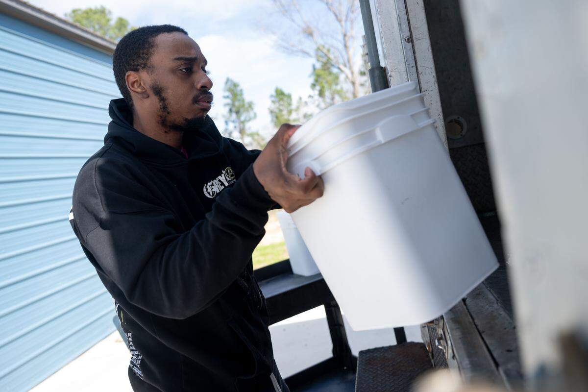 Kaleb Heidelberg loads ice cream onto a truck headed to the Quakes Ice Creamery in Ocean Springs at the new Quakes distribution center in Vancleave.