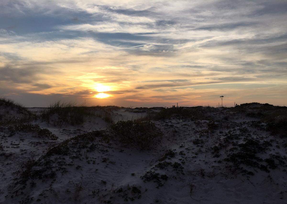 Sunset on Horn Island on Saturday, May 14, 2016. Hazardous remains left from when the island was a chemical test site during World War II have been remained, and the island is a favorite for campers.