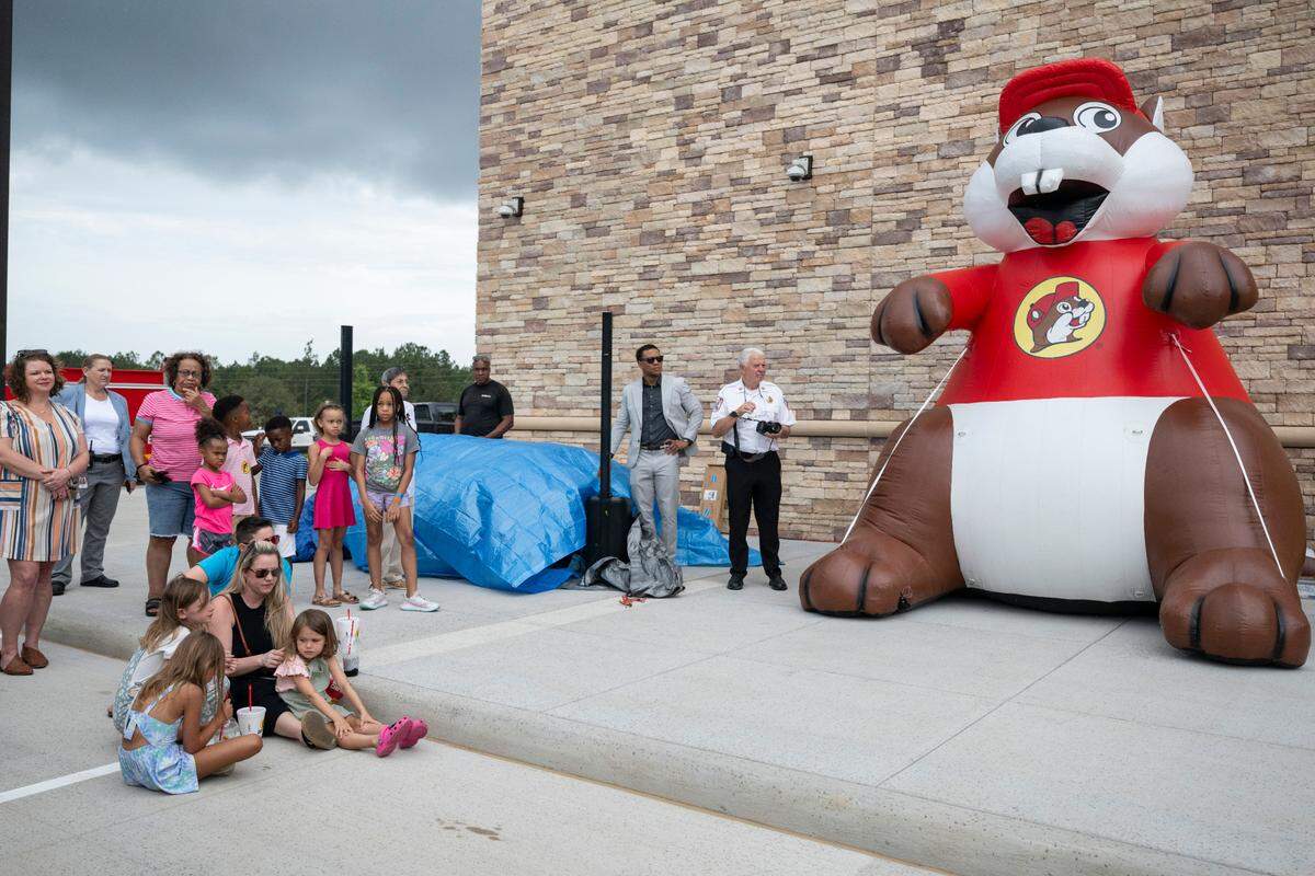 Families relax during a ribbon cutting ceremony for Buc-ee’s first Mississippi location in Harrison County on Monday, June 9, 2025.