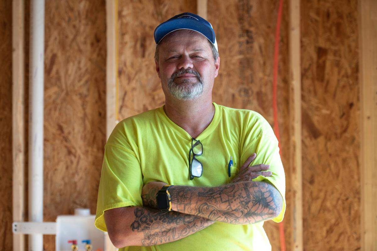 Shane McNeely, owner of Airlogy of Mississippi, poses for a portrait at a new construction home in Biloxi where his HVAC company was installing an air conditioning system on Thursday, Aug. 17, 2023.
