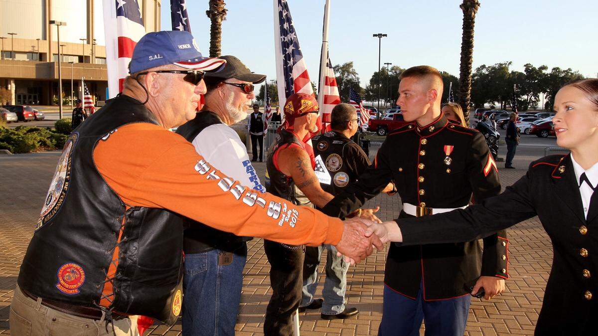 TIM ISBELL/SUN HERALDLarry Middleton and Joe Giles of the Patriot Guard shake hands with U.S. Marines as they arrive for the 37th annual Salute to the Military in Biloxi on Oct. 20.