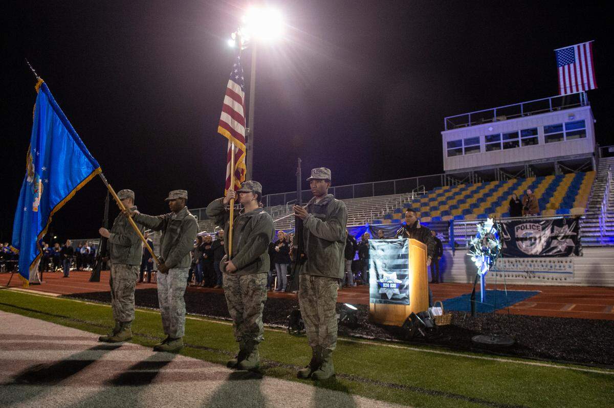 Jr. ROTC presents flags during a candlelit vigil for Bay St. Louis Sgt. Steven Robin and officer Branden Estorffe at Tiger Stadium in Bay St. Louis on Thursday, Dec. 15, 2022.