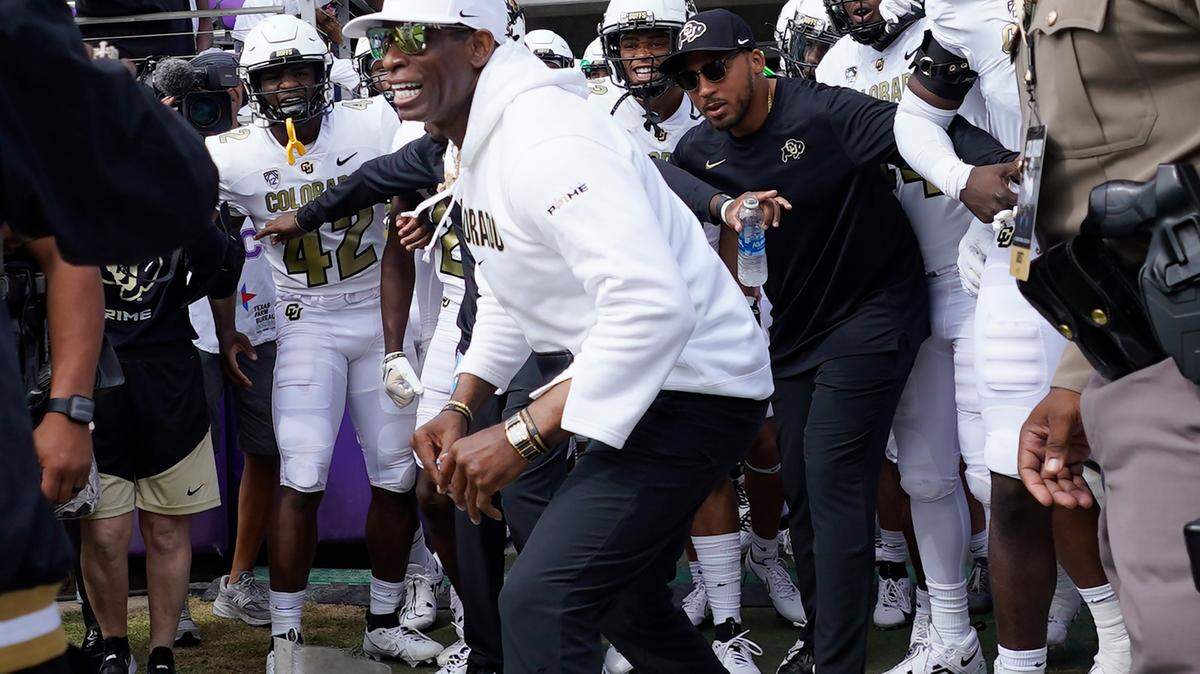 Colorado head coach Deion Sanders runs onto the field with his team for an NCAA college football game against TCU Saturday, Sept. 2, 2023, in Fort Worth, Texas. (AP Photo/LM Otero)