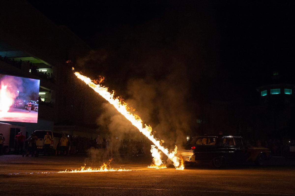 Jason Hamilton’s 1962 Mercury Monterey shoots flames of the tailpipes onto the ground during a flame throwing competition, where drivers compete to see which car can produce the biggest flames, at Island View Casino in Gulfport during Cruisin’ The Coast on Tuesday, Oct. 5, 2021.