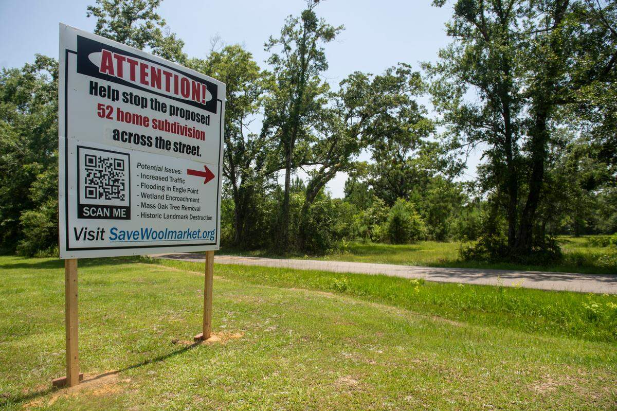 A sign encouraging community members to stop a new development stands across from a proposed subdivision on Shorecrest Road in Woolmarket on Thursday, June 16, 2022.