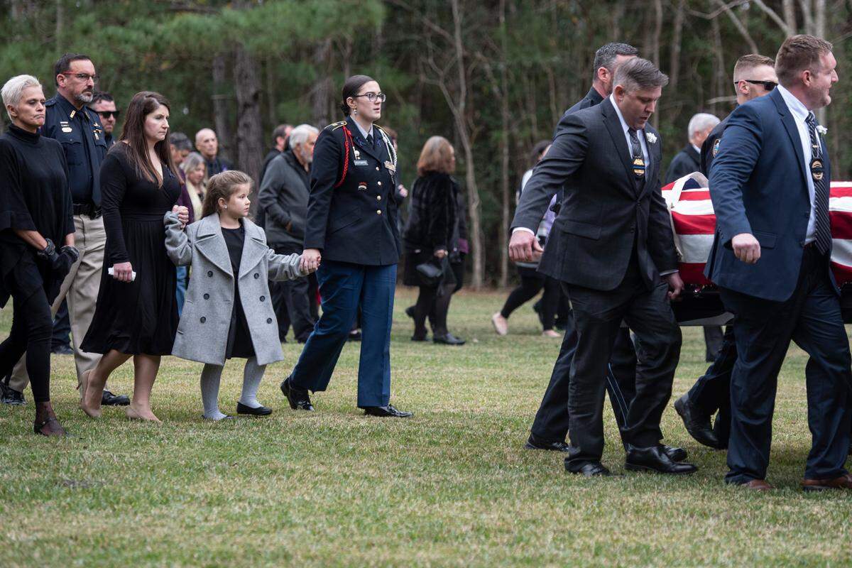 Family members of Branden Estorffe follow the caskets of Bay St. Louis police officers Sgt. Steven Robin and Branden Estorffe to their gravesite at Gardens of Memory cemetery in Bay St. Louis on Wednesday, Dec. 21, 2022. Robin and Estorffe were killed responding to a call at a Motel 6 on Dec. 14.