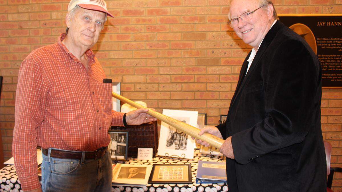JEFF CLARK/SUN HERALD 
 Gene Alexander and Ron Dyal check out some of the memorabilia at a birthday celebration for baseball great Dizzy Dean on Saturday in Wiggins.