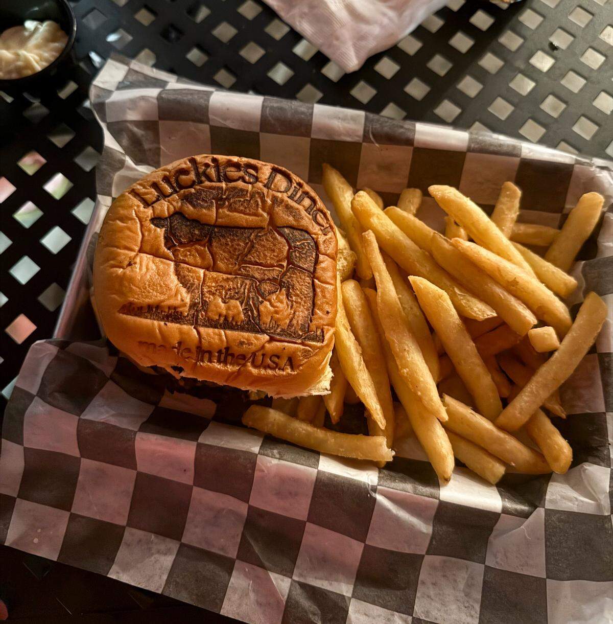 A burger at Luckies Diner in Vancleave comes branded with their logo.