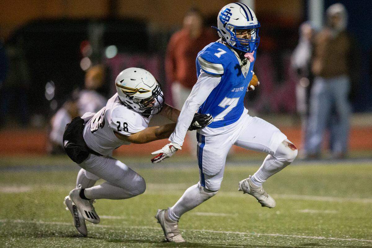 Ocean Springs’ Bryshen Smith gets tackled by Oak Grove’s Tyler Slay during a 6A playoff game at Greyhound Stadium in Ocean Springs on Friday, Nov. 18, 2022.
