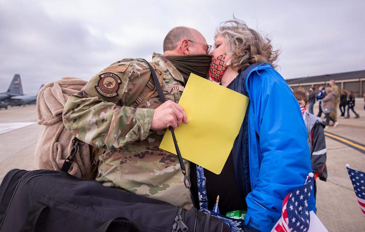 Master Sgt. Lawson Boyd gives his wife Evelyn a kiss after they are reunited at Keesler Air Force Base in Biloxi, Mississippi Saturday, Feb. 13, 2021. Boyd has been gone for five months after the 815th Airlift Squadron and maintenance and support personnel throughout the 403rd Wing were deployed to Southwest Asia in November 2020. 
