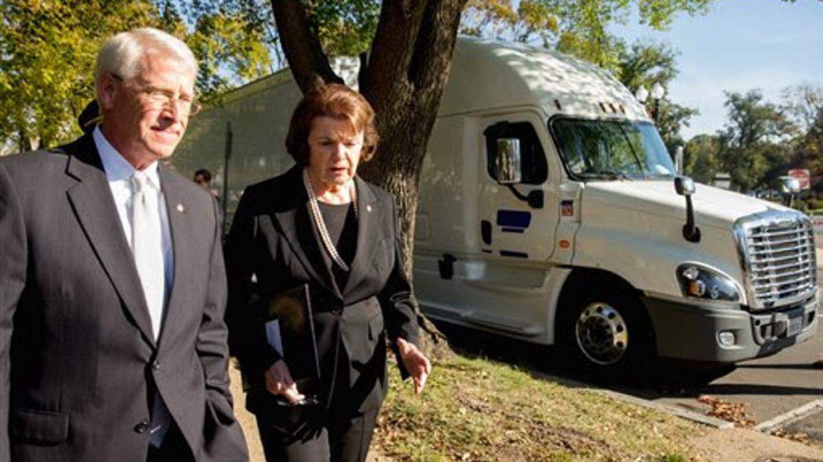 ANDREW HARNICK/APSen. Roger Wicker, R-Miss., left, and Sen. Dianne Feinstein, D-Calif., right, walks past a double trailer truck before a news conference on the West Front of the Capitol in Washington Wednesday. The lawmakers voiced their bipartisan opposition to a federal mandate that would allow large trucks to pull double 33-foot trailers on the nation's highways.