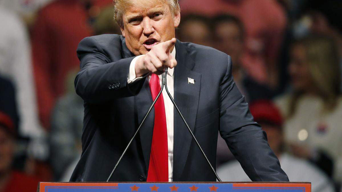 FILE - In this Feb. 26, 2016, file photo, Republican presidential candidate Donald Trump gestures during a speech at a rally in Oklahoma City. Democrats increasingly view Trump as the likely Republican nominee and are seeking consensus on the best way to challenge the billionaire's unpredictable appeal in a general election. (AP Photo/Sue Ogrocki, File)