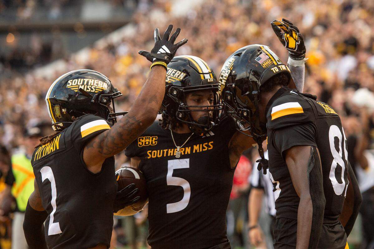 Southern Miss Golden Eagles running back Chandler Pittman (2), Southern Miss Golden Eagles running back Kenyon Clay (5) and Southern Miss Golden Eagles tight end Kyirin Heath (85) celebrate after a touchdown during a game between Southern Miss and South Florida at M.M. Roberts Stadium in Hattiesburg on Saturday, Sept. 14, 2024.