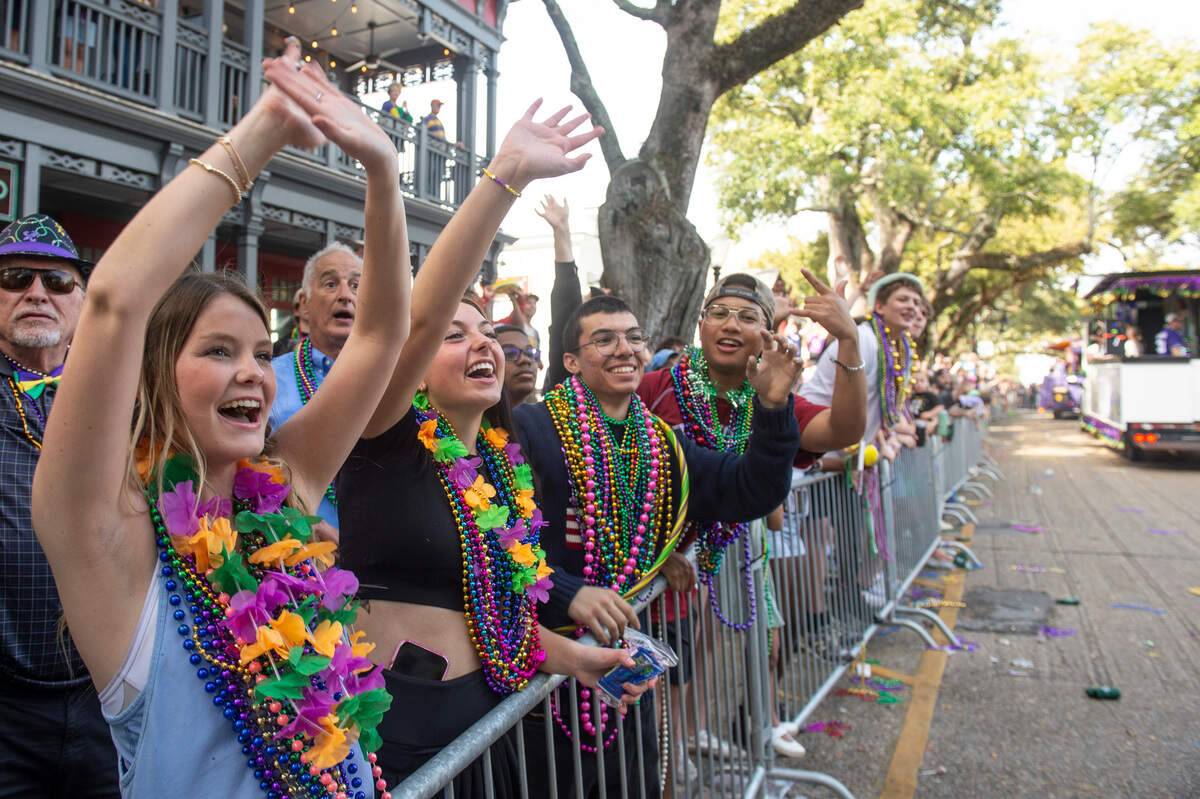 Parade watchers cheer for throws during the Ocean Springs Elks Club Mardi Gras Parade in Ocean Springs on Saturday, Feb. 15, 2025.