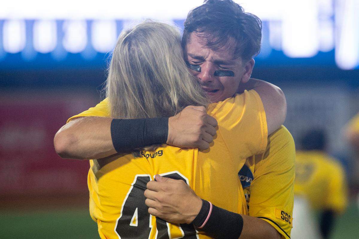 Southern Miss’ Dustin Dickerson hugs his family after Southern Miss lost to Tennessee in the NCAA Super Regional at Pete Taylor Park in Hattiesburg on Monday, June 12, 2023.