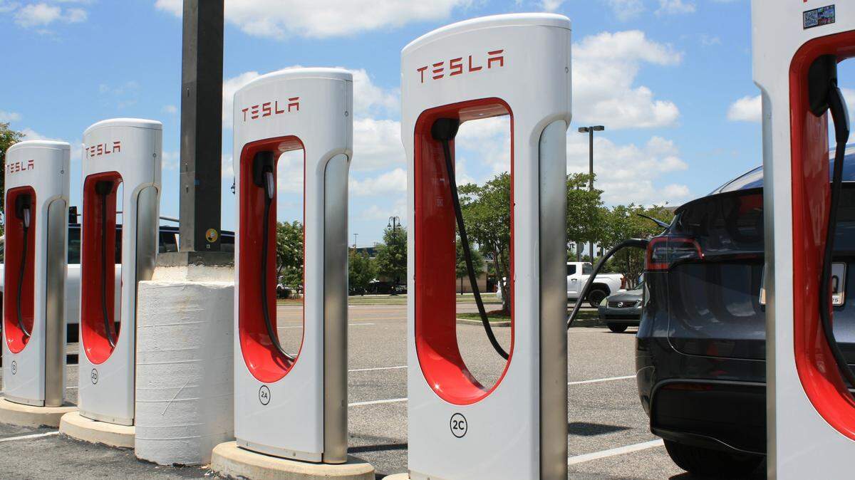 A car is plugged into the Tesla Supercharger in D’Iberville.