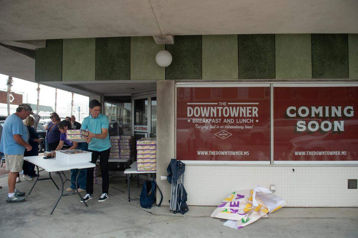 Staff sell Loblolly Bakery king cakes during a pop-up sale in Gulfport on Friday, Feb. 7, 2025. The Hattiesburg-based bakery held the pop-up outside what will be The Downtowner, a new restaurant in the same restaurant group as Loblolly.