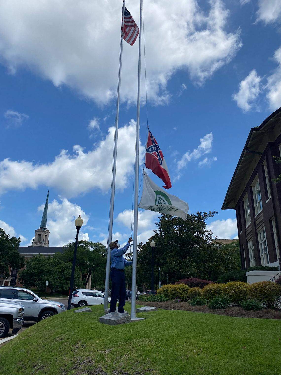 Laurel official lowers Mississippi state flag outside City Hall on June 23, 2020.