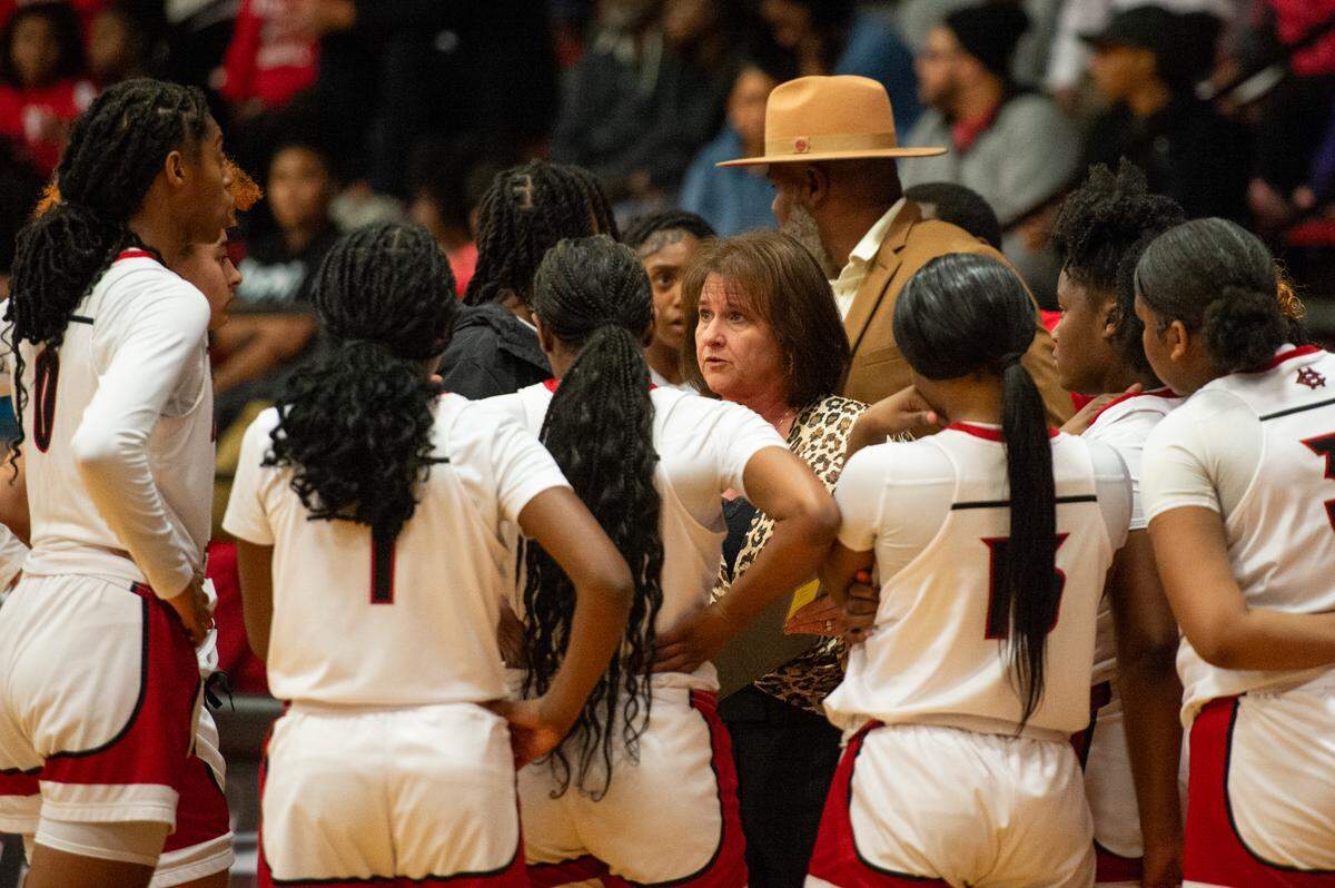 Harrison Central Head Coach Nancy Ladner takes a time out with her players during a game against Biloxi at Harrison Central High School in Harrison County on Tuesday, Dec. 12, 2023.