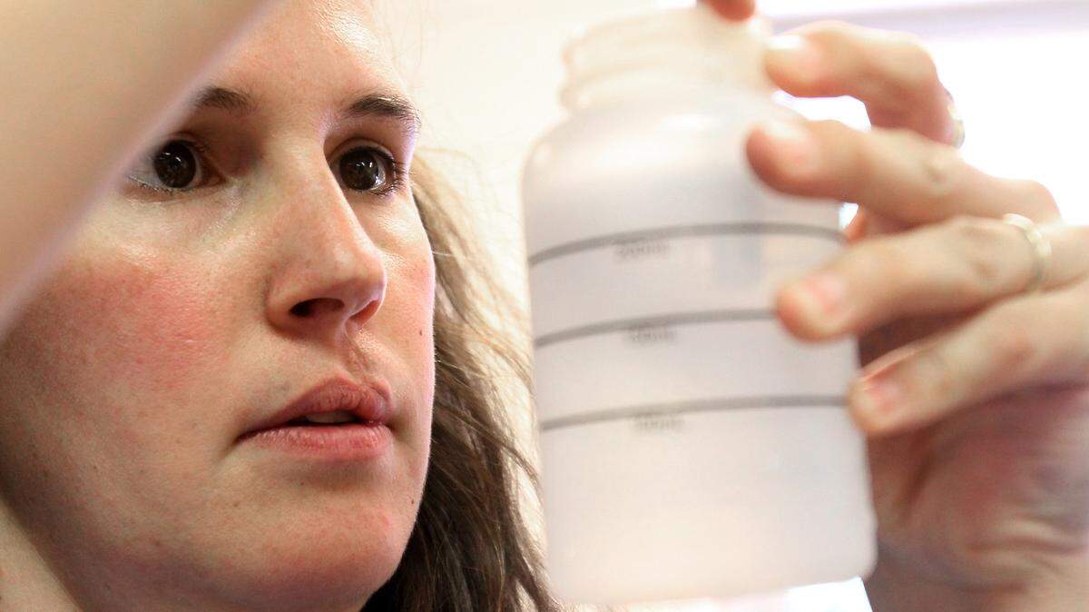 AMANDA McCOY/SUN HERALDMisty Fiello, research technician with the Southern Miss Gulf Coast Research Lab, tests samples from the beach for enterococci bacteria at GCRL in 2011.