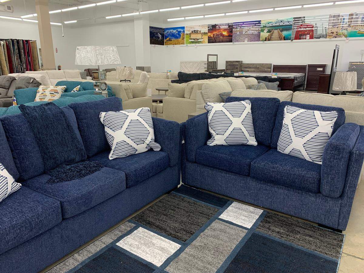 Modern furniture with high contrast pillows and rugs in equally modern styles are featured at this new store in Biloxi.