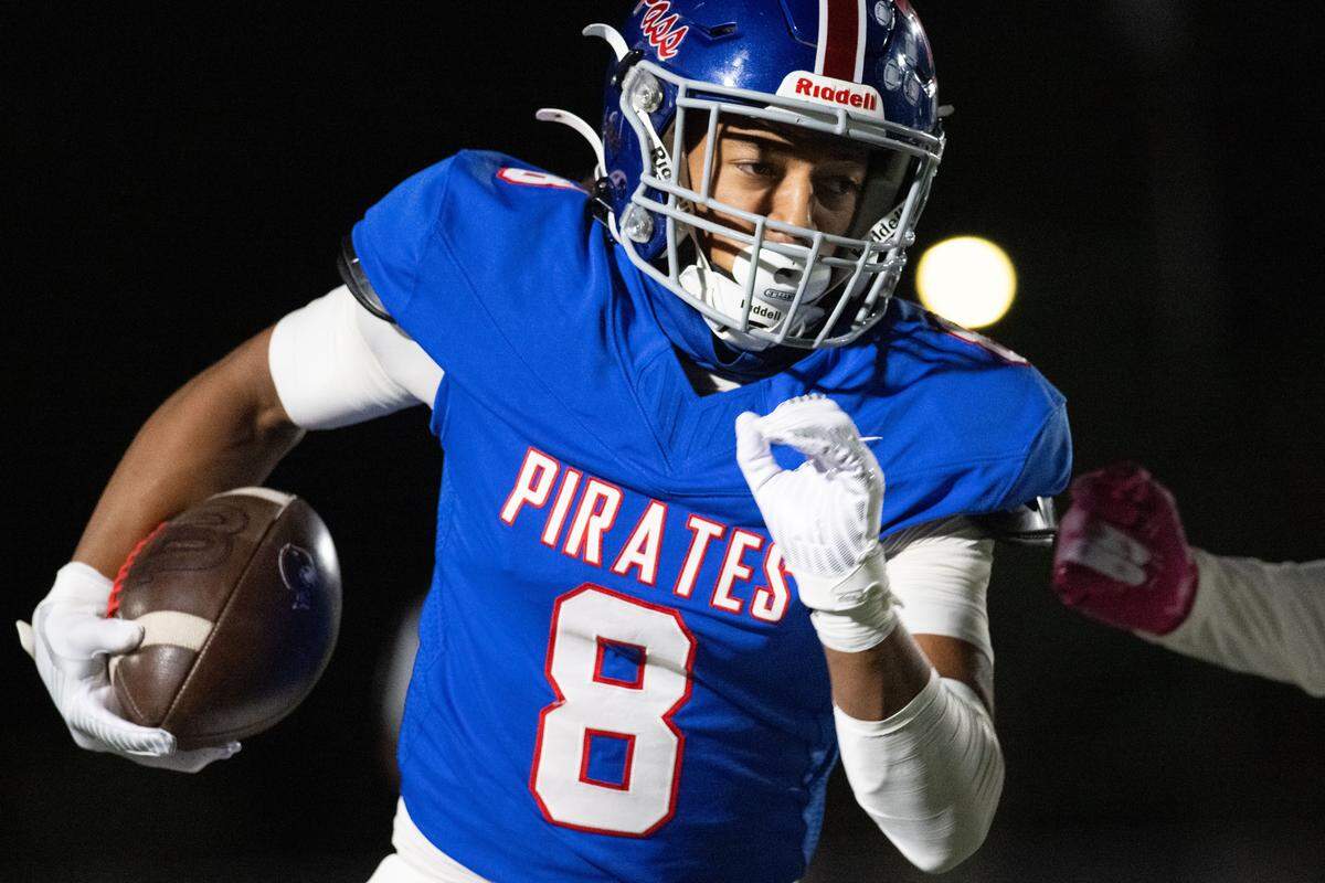 Pass Christian wide receiver Larkin Lewis (8) picks up yards Friday in the Pirates’ victory over Moss Point.
