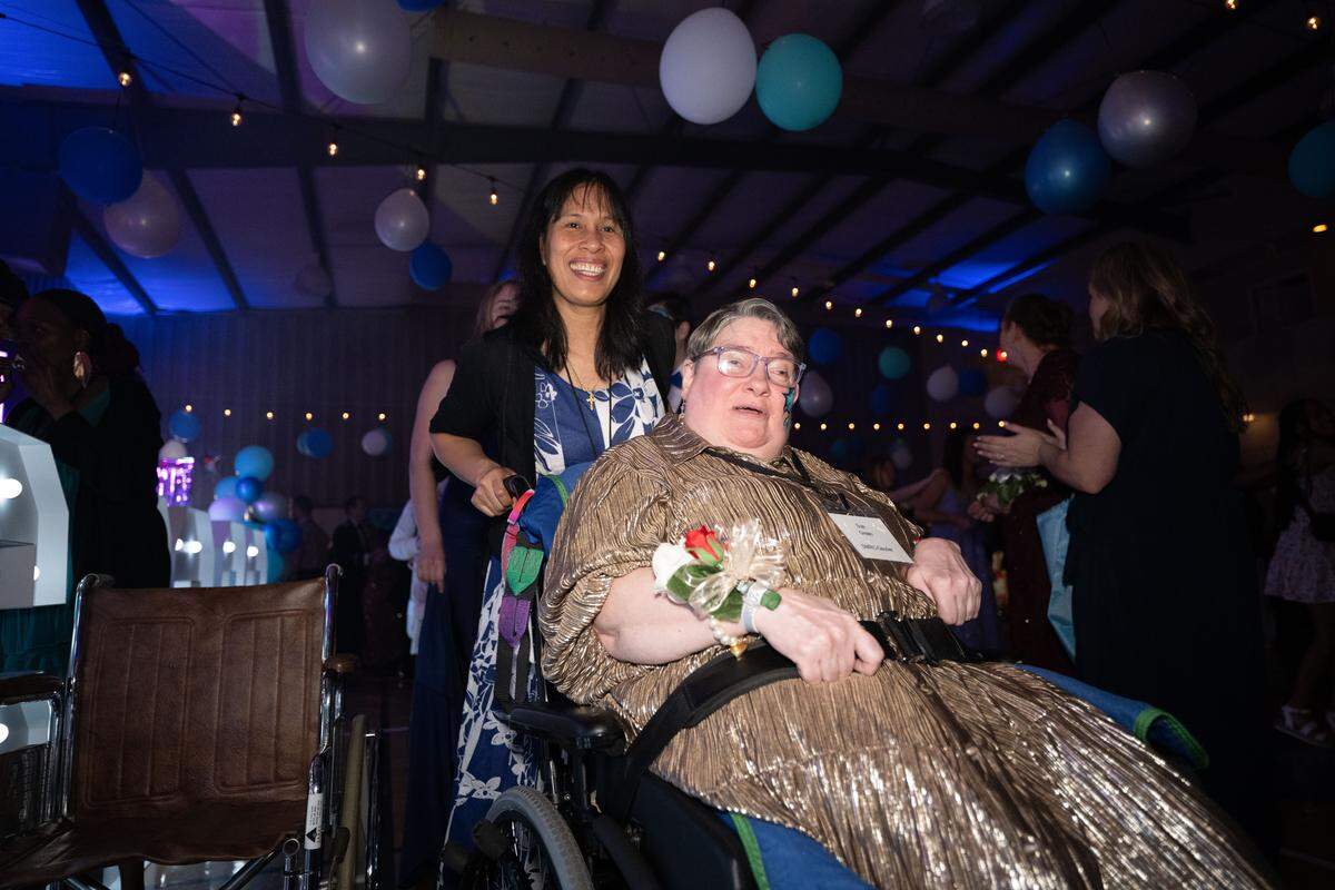 Sue Green is pushed around the dance floor by her buddy during Night to Shine at Woolmarket Baptist Church on Friday, Feb. 13, 2026.