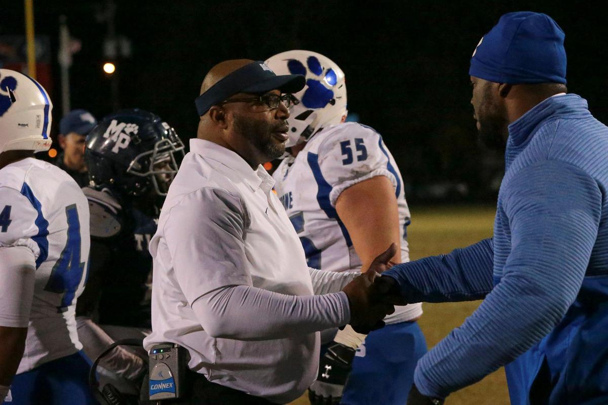 Moss Point head coach Eugene Harmon and Stone County head coach John Feaster shake hands after the Tigers win the first round 4A playoff game between Moss Point and Stone at Moss Point, Friday, November 8, 2019.