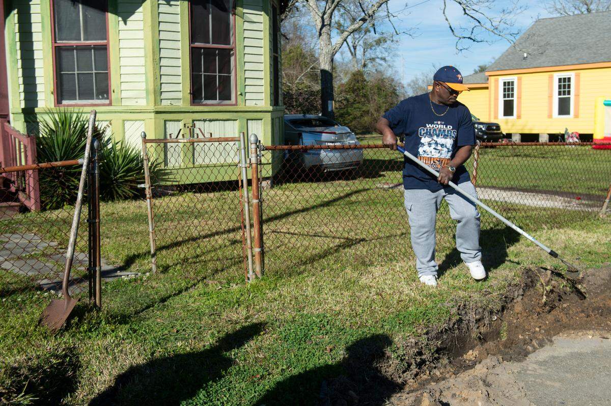 Edward Robinson, Darold Payne’s uncle, attempts to repair tire tracks left by law enforcement vehicles at the home of Harold Payne and Jittaun Payne in Pascagoula on Thursday, March 6, 2025. The Paynes were killed on Wednesday when their son Darold Sim Payne allegedly beat them to death with a cinderblock.
