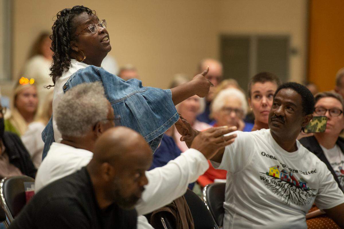 An Ocean Springs resident argues as another resident addresses the mayor and Board of Aldermen during a public hearing about a proposed Urban Renewal Plan at the Ocean Springs Civic Center on Monday, Oct. 2, 2023.