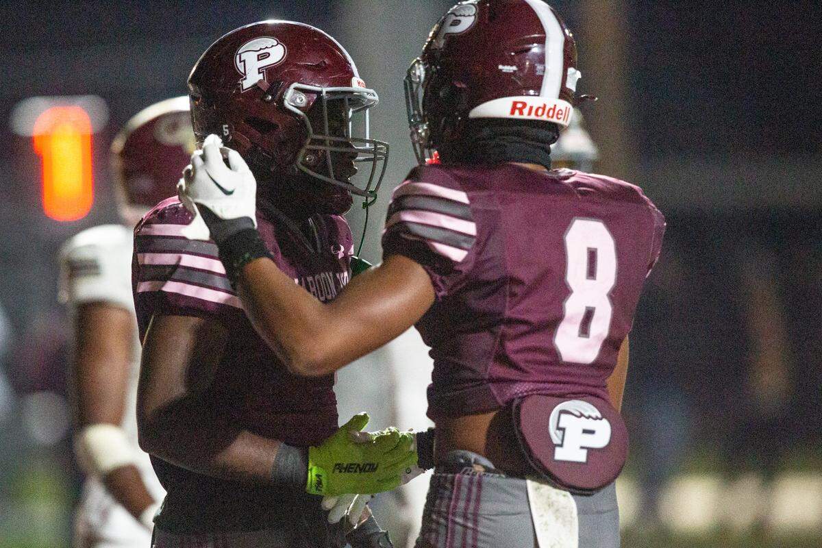 Picayune’s Triston Cooper and BJ Ducre celebrate after a touchdown during a playoff game between Picayune and George County at Lee-Triplett Stadium in Picayune on Friday, Nov. 22, 2024.