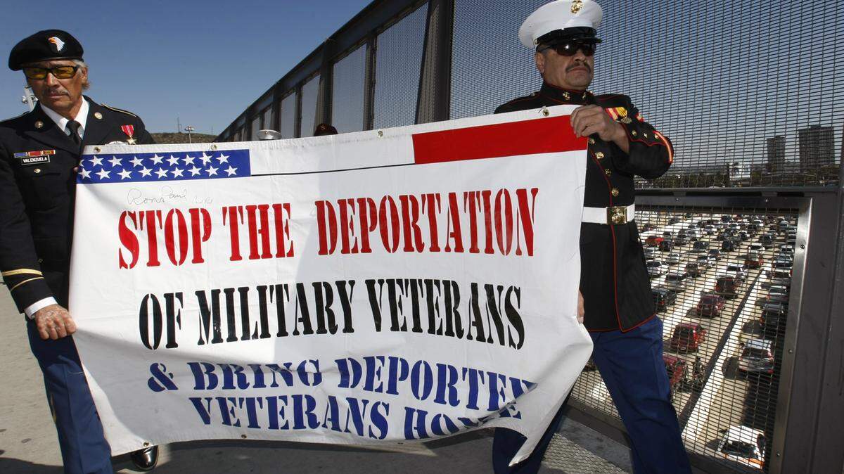Fromer Army Sgt. Valente Valenzuela and former Marine Lance Cpl. Manuel Valenzuela protest in San Ysidro, Calif., in 2012. Each served three years in the U.S. military before they were ordered deported. (Don Bartletti/Los Angeles Times/TNS)
