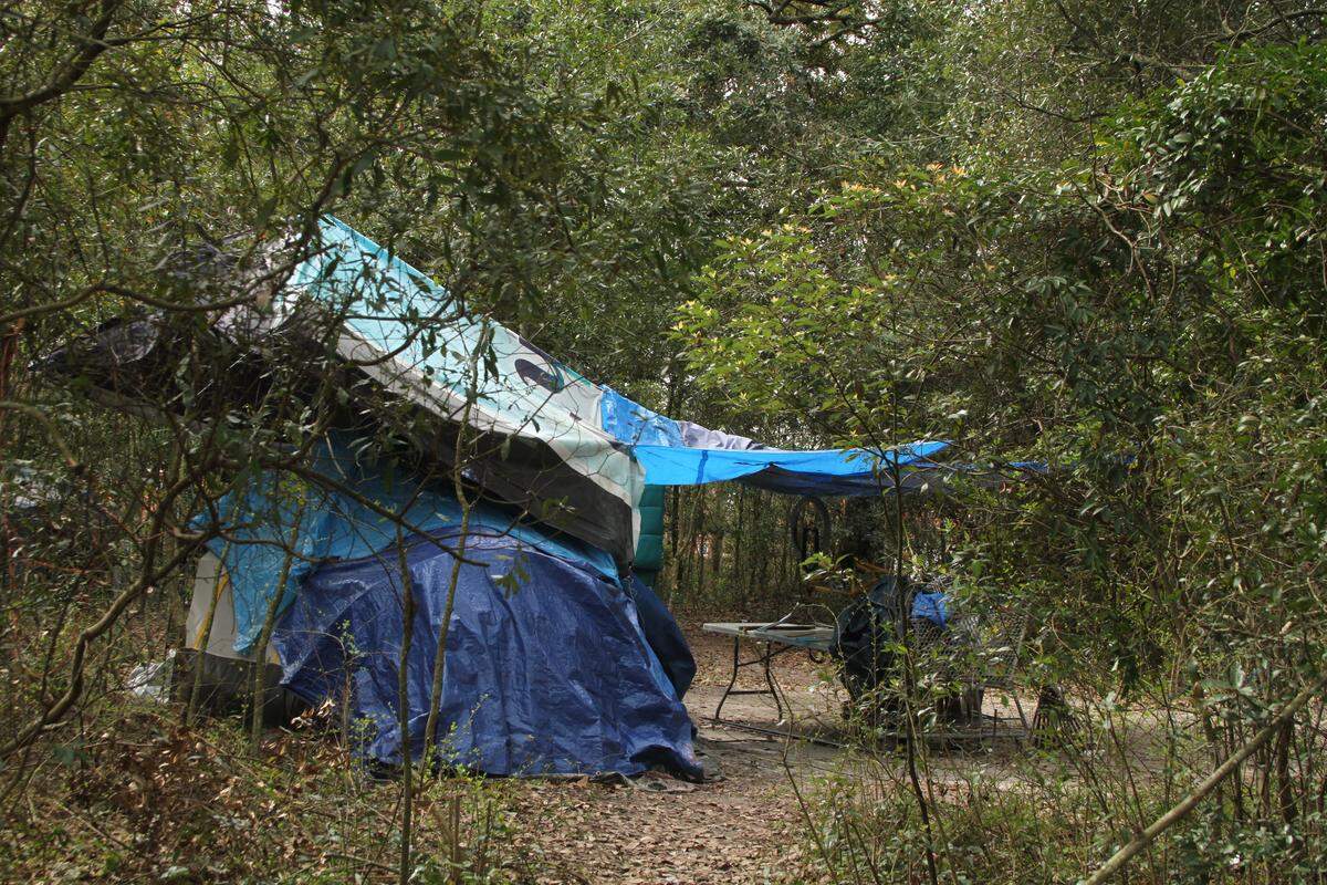 This file photo from 2019 shows a tent at one of numerous camps scattered through the woods beside the Kansas City Southern rail line that runs north-south through Gulfport. A new Homeless Resource Center will offer day shelter and services in Gulfport, which provided a federal CARES Act grant of more than $1 million for the project.