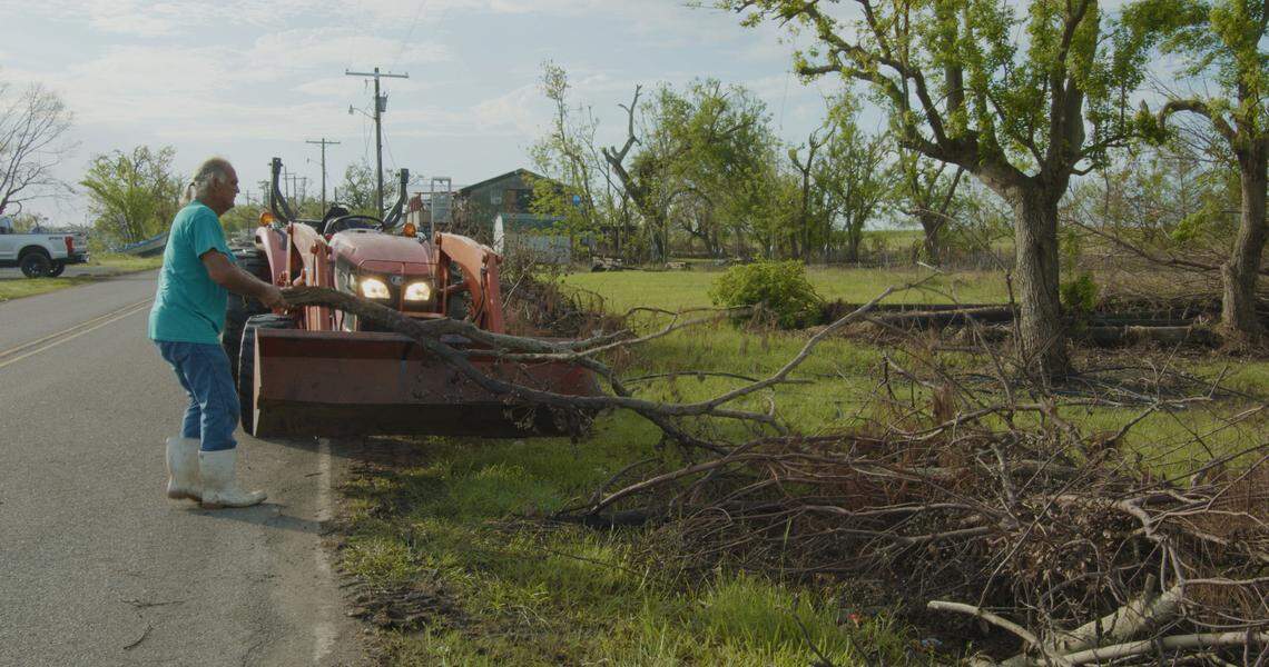 Donald Dardar cleans off debris from Hurricane Ida off the streets of Pointe-Aux-Chenes, LA. Weeks after the storm, in September 2021, the community was still without electricity and water.