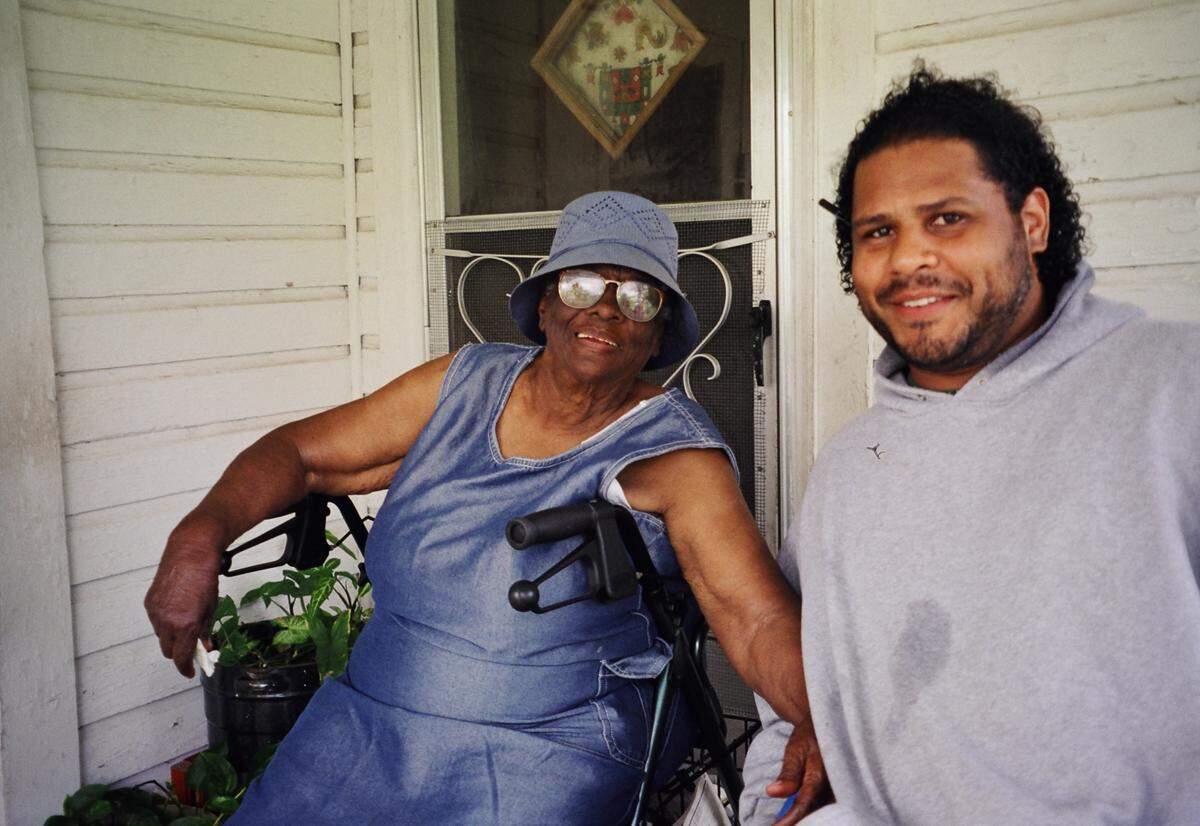 Turkey Creek resident Eva Skinner, left, visits with sixth-generation community member Derrick Evans before they filmed the opening scene of a dcoumentary about Turkey Creek Skinner lost husband Lee in a 1943 explosion at a plant that employed many Turkey Creek residents. The plant used a volatile process to extract turpentine and other materials from pine stumps and knots.