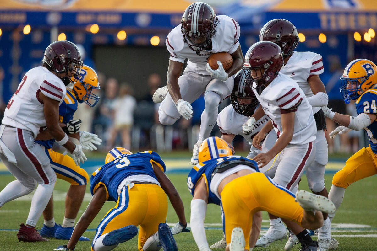 Long Beach’s Andre Windham jumps over players as he runs the ball during a game between Bay High and Long Beach at Tiger Stadium in Bay St. Louis on Friday, Sept. 13, 2024.