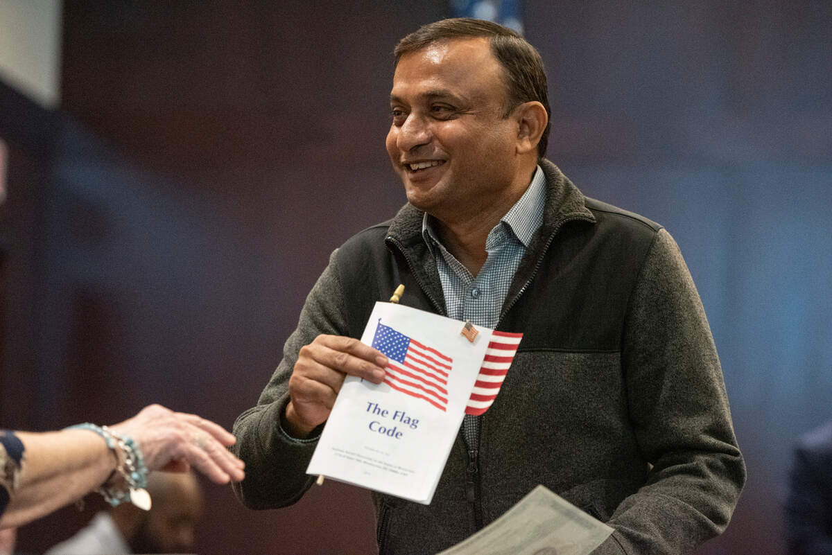 Members of daughters of the American Revolution hand out American flags and pins to newly naturalized American citizens during a naturalization ceremony at Dan M. Russell Courthouse in Gulfport on Thursday, Oct. 19, 2023.