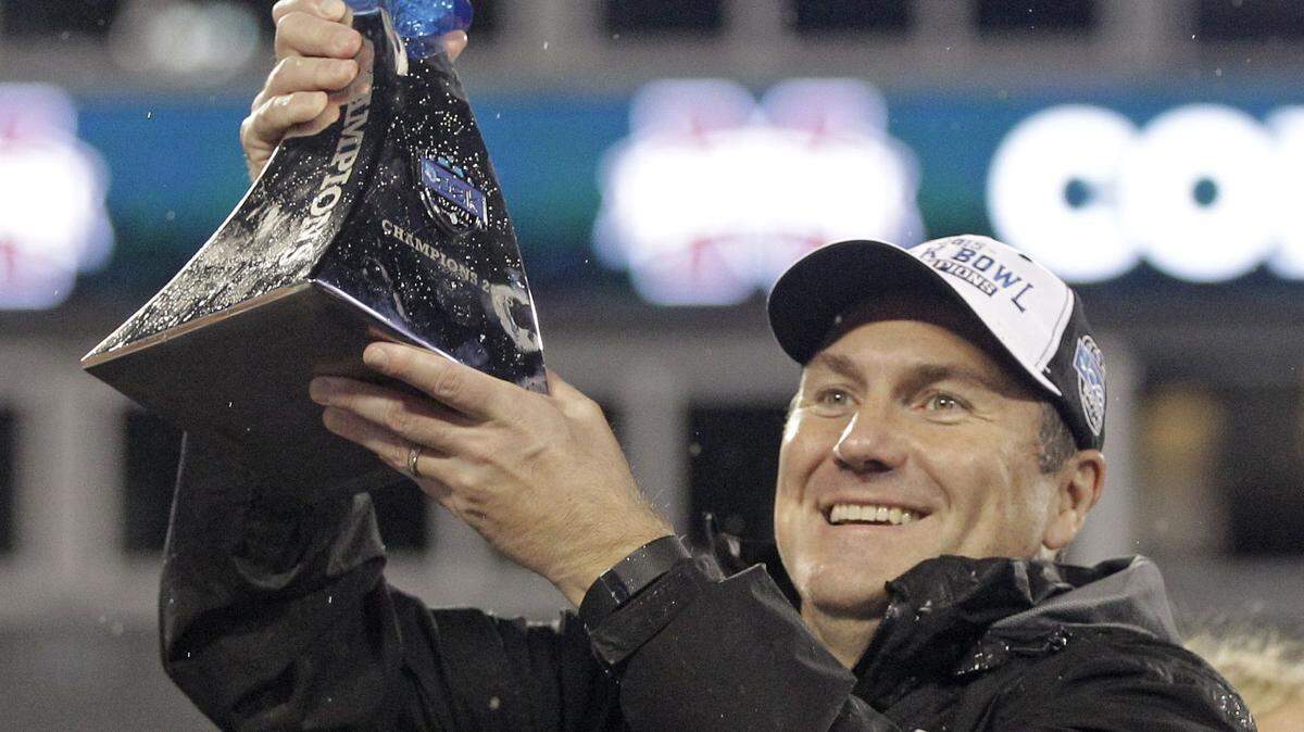 Mississippi State coach Dan Mullen raises the trophy after the team won the Belk Bowl NCAA college football game against North Carolina State in Charlotte, N.C., Wednesday, Dec. 30, 2015. Mississippi State won 51-28. (AP Photo/Nell Redmond)