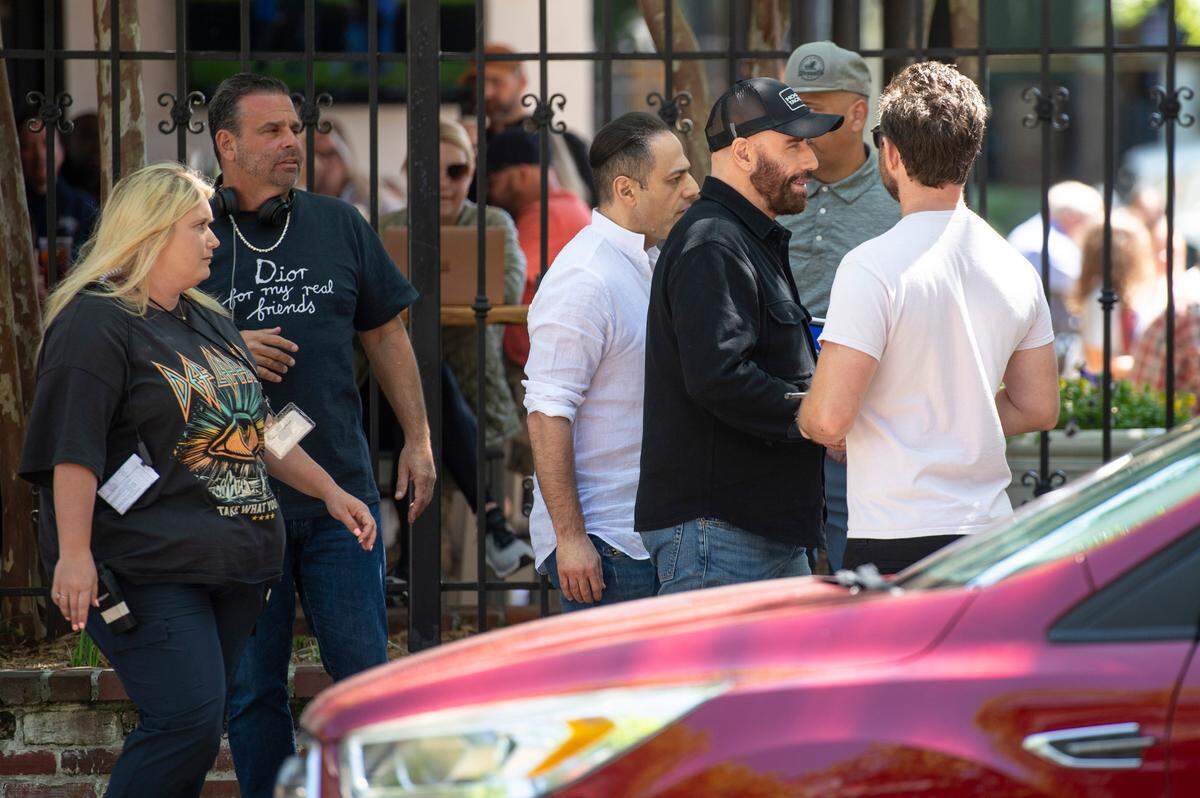 Actor John Travolta, center right, on the set of Cash Out 3 during filming on Washington Avenue in Ocean Springs on Tuesday, April 8, 2025.