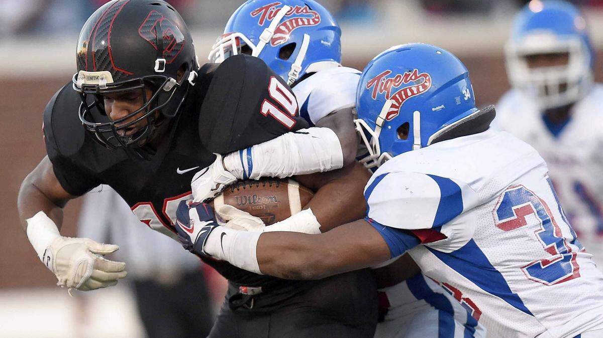St. Stanislaus receiver Darius Pittman (10) secures the ball against two Noxubee defenders on Saturday, December 5, 2015, in the MHSAA Class 4A State Football Championship in Vaught-Hemmingway Stadium on the Ole Miss campus in Oxford, Miss.