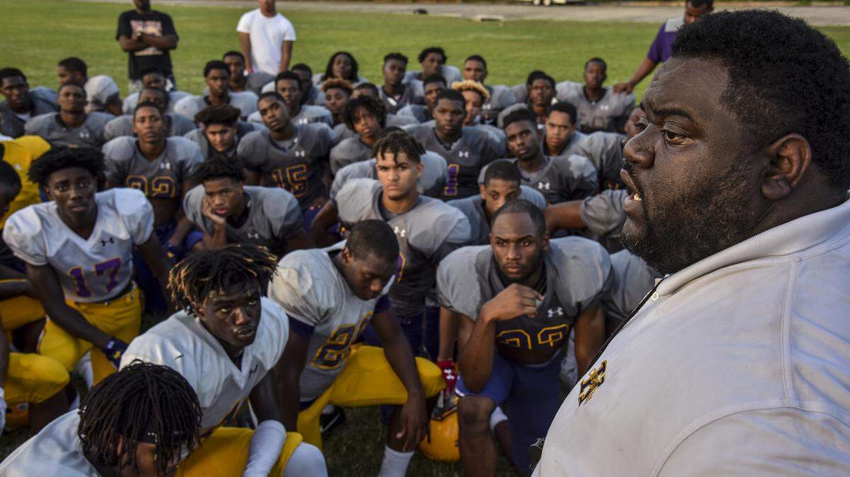 Edna Karr High football coach Brice Brown speaks to his team following practice Aug. 13 in New Orleans.