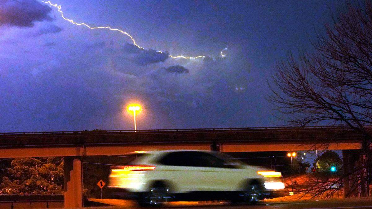 File Photo: A vehicle races along a Jackson, Miss., street as lightning streaks across the sky, Tuesday evening, Nov. 29, 2022. Area residents were provided a light show as severe weather accompanied by some potential twisters affected parts of Louisiana and Mississippi. (AP Photo/Rogelio V. Solis)