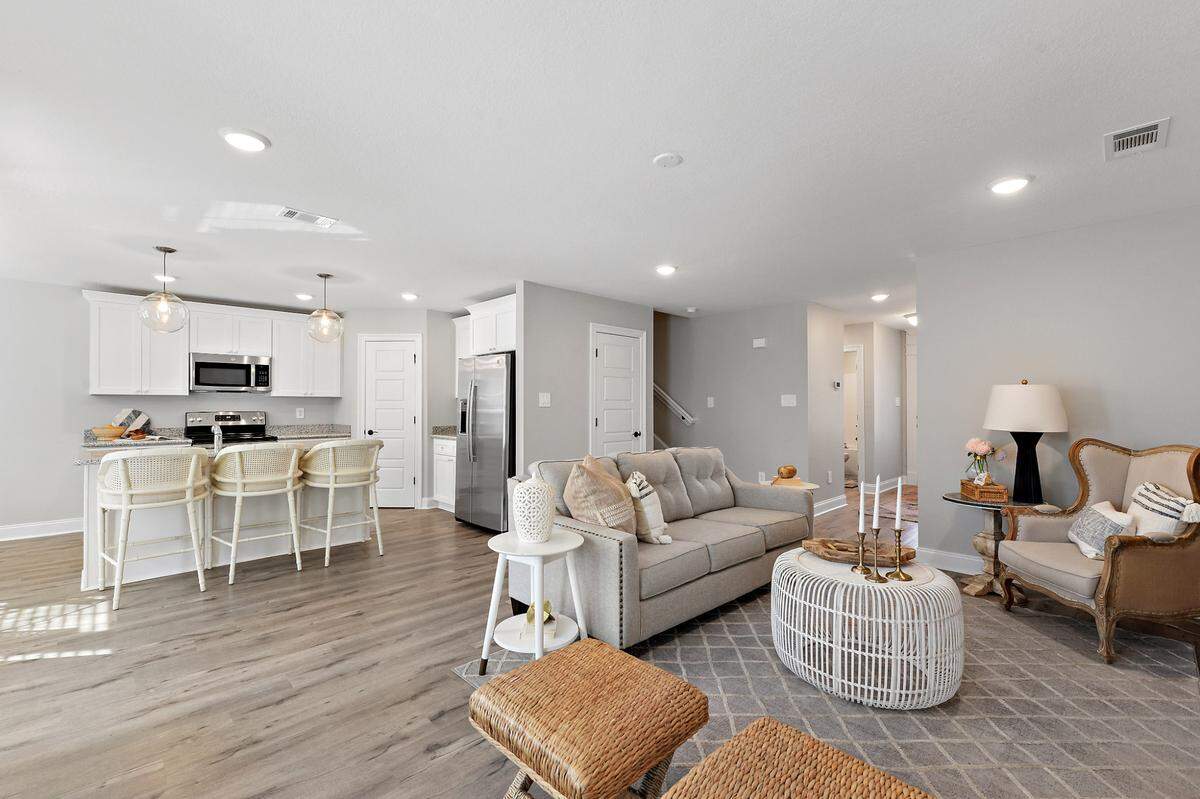 The interior of The Kai, a cottage built by Elliott Homes, shows the vinyl plank flooring used throughout, stainless appliances and soft-close cabinets.