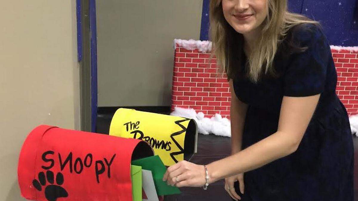 JEFF CLARK/SUN HERALD 
 Salvation Army Public Relations Director Morgan Shiyou checks Snoopy's mailbox as she prepares for "A Charlie Brown Christmas" at the Kroc Center.